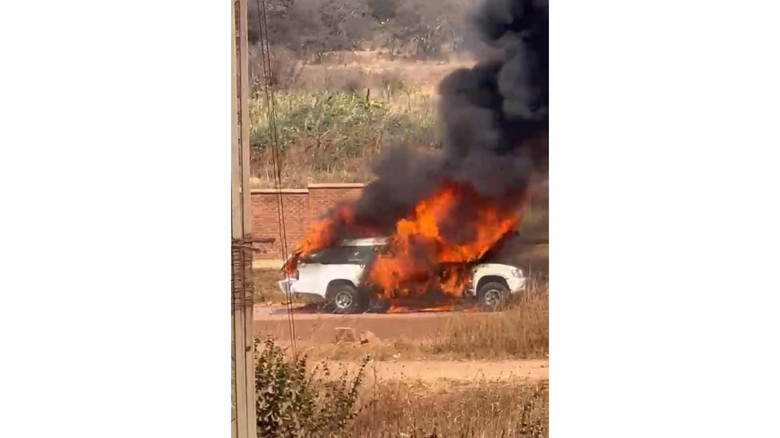 MOURNERS SCRAMBLE TO RETRIEVE COFFIN AS HEARSE CATCHES FIRE