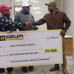 Cde Evans Kamombo (right) hands over the US$5 000 donation to Nyanga DCC leadership meant to help the district in its participation at the national ZANU PF annual People's Conference