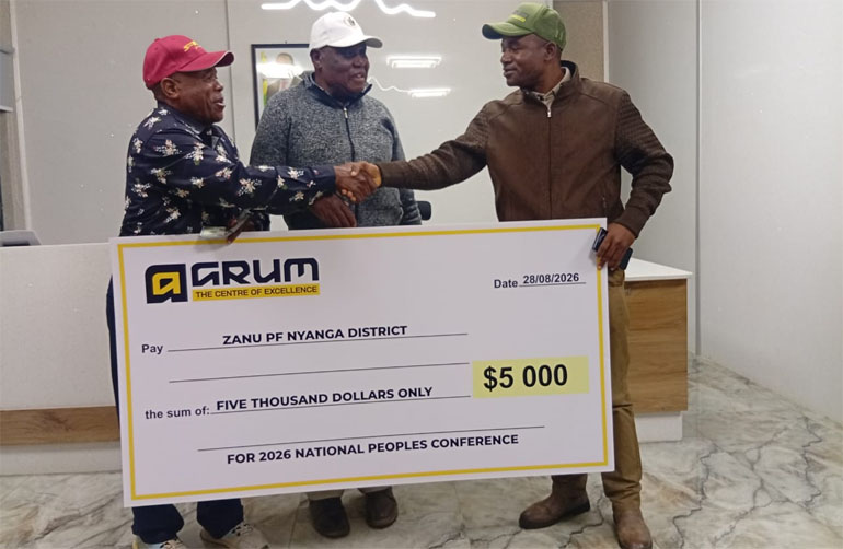 Cde Evans Kamombo (right) hands over the US$5 000 donation to Nyanga DCC leadership meant to help the district in its participation at the national ZANU PF annual People's Conference