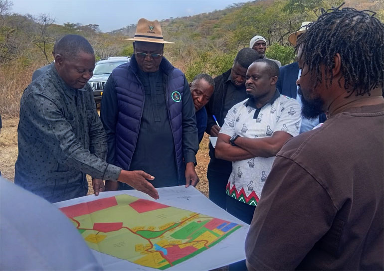 Sports, Recreation, Arts and Culture Minister, Lieutenant General (Rtd) Ambassador Anselem Nhamo Sanyatwe and Permanent Secretary in the Ministry, Mr Nicholas Moyo, being shown the map and intended land uses at Mount Worsley Estate near Mutare on Monday