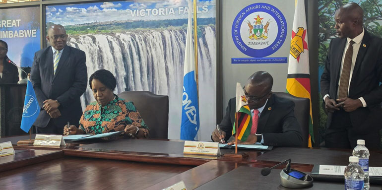 Caption: Foreign Affairs and International Trade Minister, Professor Amon Murwira, (seated right) and COMES Secretary General, Ms Chileshe Mpundu Kapwepwe, (also seated left) sign the hosting agreement in Harare on Monday