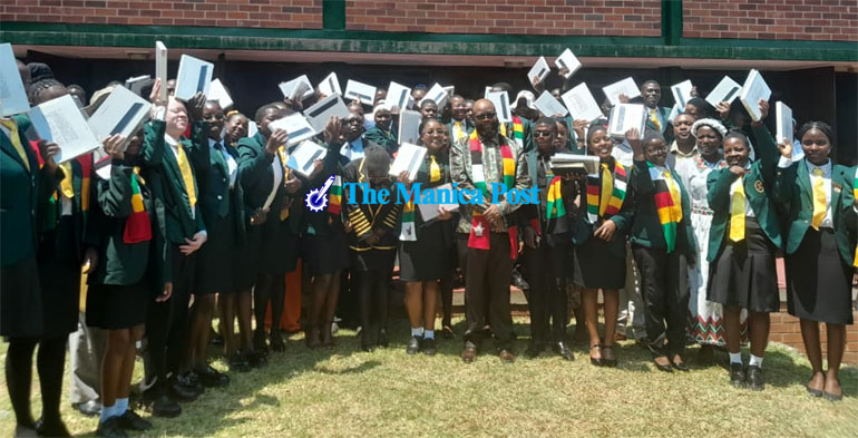 Minister of State for Manicaland Provincial Affairs and Devolution, Honourable Misheck Mugadza hands over Samsung tablets to Juniour Parliamentarians donated by President Mnangagwa and three robotic kits donated by TechTrek International at Mutare Boys’ High School today