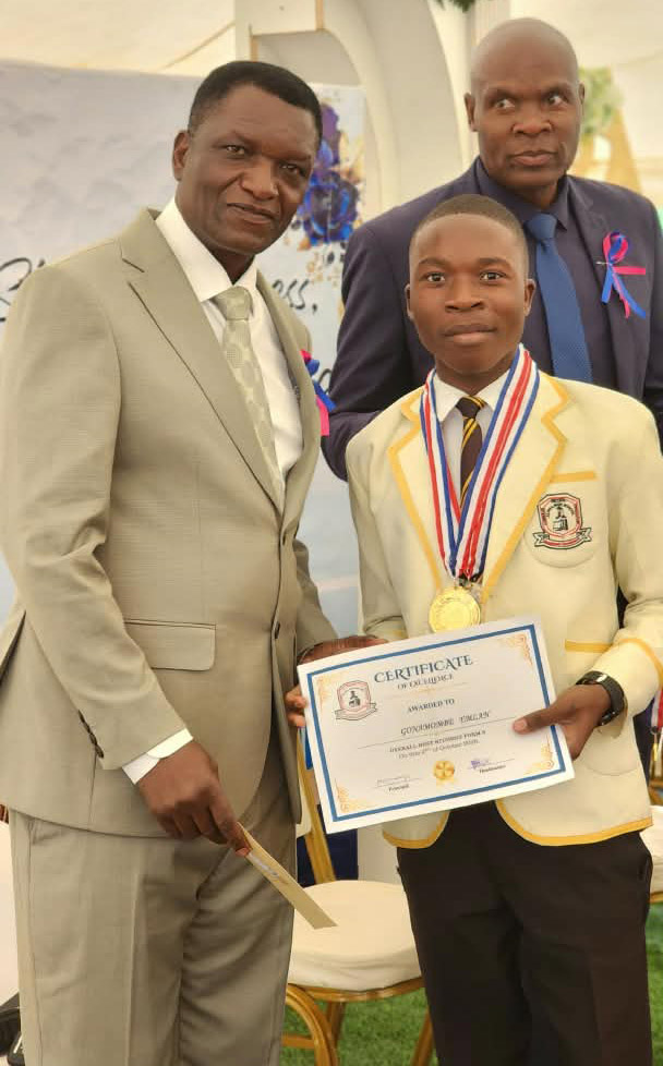 Mr Mandeya hands over a certificate to one of the top performers, while Mr Marange looks on