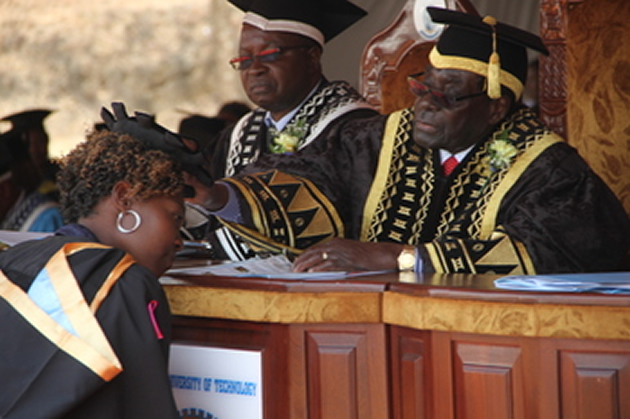 President Mugabe caps Ms Prisca Mbwana who graduated with a first class BSc Honours Degree in Hospitality and Tourism at Chinhoyi University of Technology yesterday. Looking on is vice chancellor Professor David Simbi