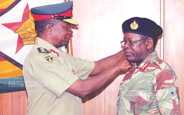 Commander Defence Forces General Philip Valerio Sibanda confers the rank of Major-General on Hlanganani Dube at Josiah Magama Tongogara Barracks in Harare yesterday. - (Picture by Innocent Makawa)