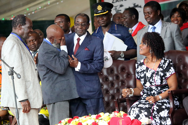 Cde Thomas Paul Ziki (second from left) sheds tears of joy as he meets his fellow ex-detainee, President Mugabe, during the 21st February Movement celebrations as First Lady Amai Grace Mugabe and other delegates look on