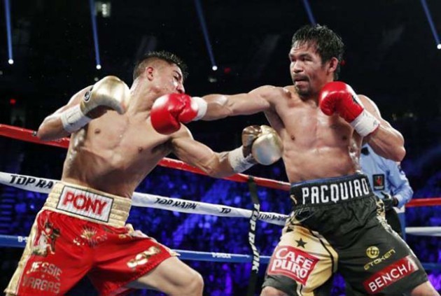 BULL’S EYE... Manny Pacquiao (right) throws a punch at Jessie Vargas during their WBO welterweight title fight in Las Vegas on Saturday night. 