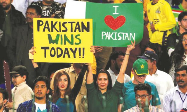 DEFYING THE ODDS . . . Pakistani fans hold placards during Sunday’s Pakistan Super League final at the Gaddafi Stadium in Lahore, which passed off successfully following a huge security operation. — Reuters