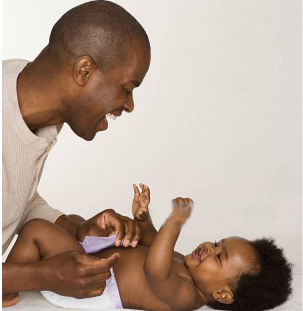 Young fathers are now spending more time with their children and even                      changing nappies