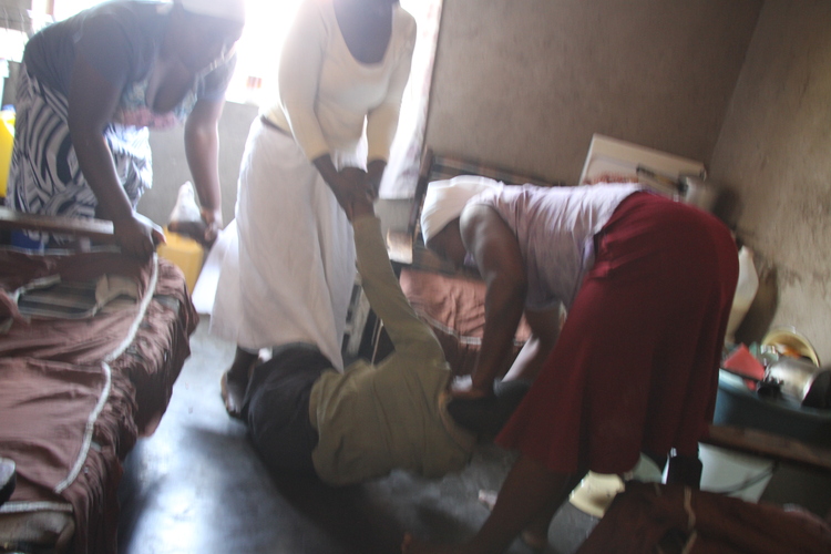 The women relatives battle to hold the girl down