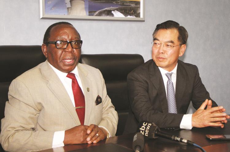 Energy and Power Development Minister Simon Khaya Moyo, flanked by Chinese Ambassador to Zimbabwe Mr Huang Ping, addresses the media in Harare yesterday. — (Picture by Memory Mangombe)