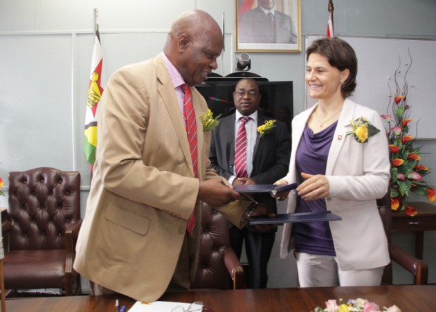 Finance and Economic Development Minister Patrick Chinamasa and Switzerland Ambassador to Zimbabwe Mrs Ruth Huber (right) exchange signed documents of an agreement on international co-operation in Harare yesterday. The agreement will see Switzerland providing at least $10 million per year to fund various developmental projects in Zimbabwe in the next five years. — (Picture by Innocent Makawa)