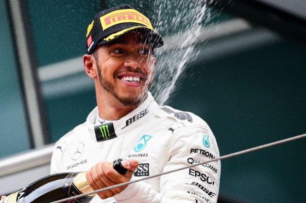 CHAMPAGNE STUFF . . . Mercedes’ British driver Lewis Hamilton celebrates with champagne on the podium after winning the Formula One Chinese Grand Prix in Shanghai yesterday. — AFP