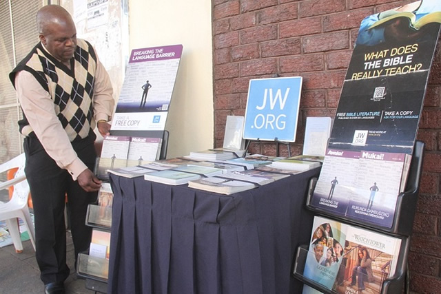 A Jehovah Witnesses literature evangelist Aaron Bvore ministers along Angwa Street in Harare