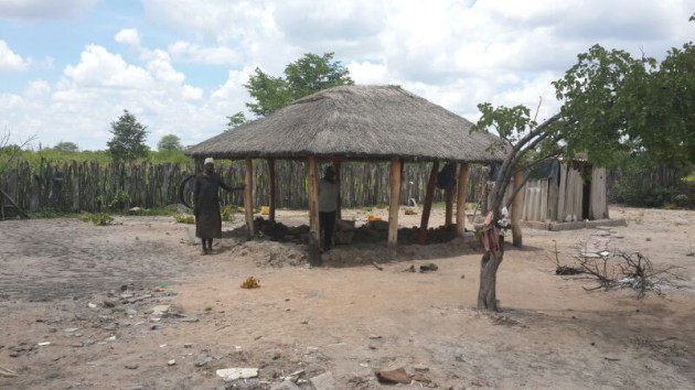 Phineas Ncube and Bheliwe Moyo inside one the huts that had it's walls washed away