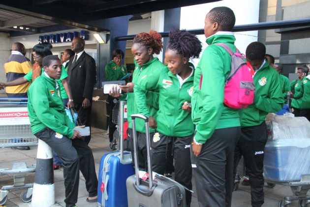 RETURN OF THE HEROINES . . . The Mighty Warriors wait for their team bus after arriving at Harare International Airport yesterday from their successful tour of duty in Zambia