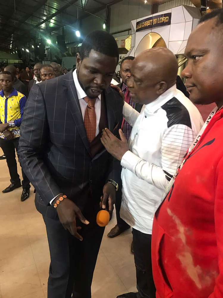 THANK YOU PARTNER . . . ZIFA president Philip Chiyangwa chats with Prophet Walter Magaya at the PHD Ministries Sunday Service where the football leadership and the Warriors went to thank the prophet for helping them in their preparations ahead of the match against Liberia