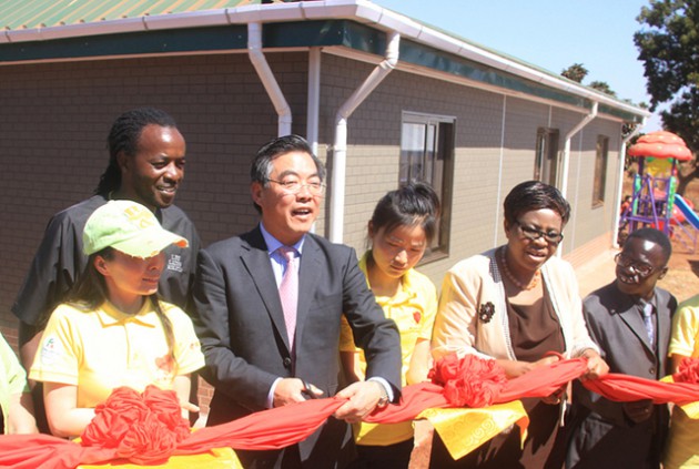 Harare Metropolitan Province Minister of State Miriam Chikukwa (second from right), Chinese Ambassador to Zimbabwe Mr Huang Ping (centre) and Harare North legislator Tongesai Mdambo cut a ribbon to officially open Hossana Love in Africa Children’s Home in Hatcliffe, Harare, yesterday. — Picture by Munyaradzi Chamalimba