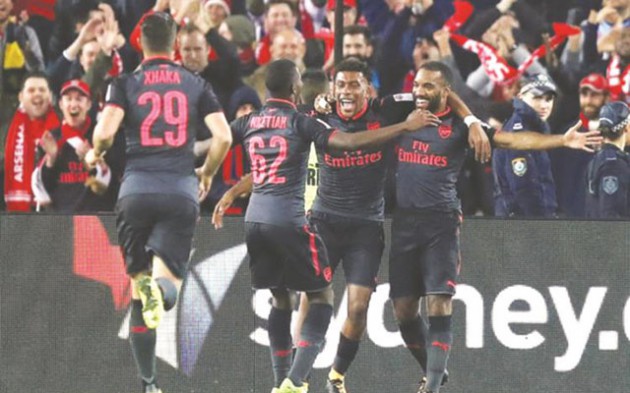 SWEET DEBUT . . . Granit Xhaka (left) runs over as Eddie Nketiah and Alex Iwobi celebrate with Alexandre Lacazette (right) after the French striker opened his account for his new club Arsenal in yesterday’s pre-season friendly match against Sydney FC in Sydney, Australia. — Mailonline