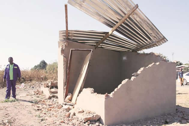 A man views one of the illegal houses that were demolished by Harare City Council in Glen Norah yesterday