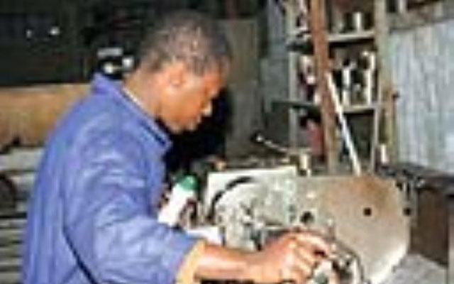Rueben Katsande operating the mining machine at Motor and General Engineering Workshop