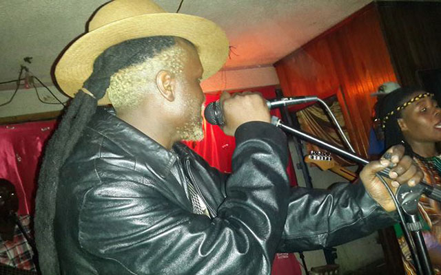 Sekurutau on stage with his group