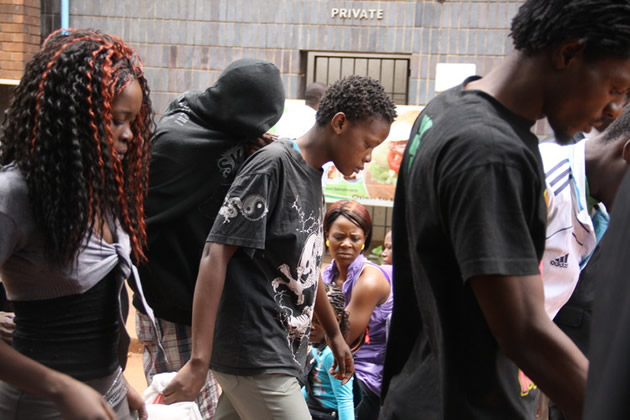 Nyarai Mutumwa (centre) was convicted of armed robbery in February and still awaits sentencing for a motor vehicle theft charge