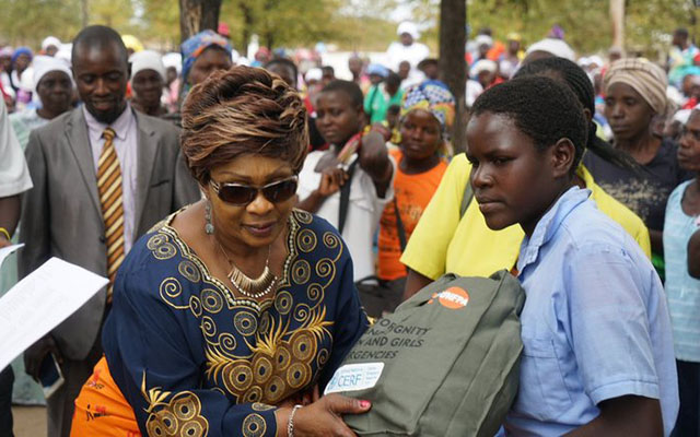 Minister of Women Affairs, Gender and Community Development Cde Nyasha Chikwinya hands dignity kits to the recipients