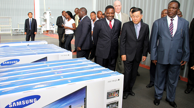 Acting President Emmerson Mnangagwa tours the SamZim plant, which assembles Samsung electronic gadgets, accompanied by the firm’s chairman Mr YC Baik and Director-General in the President’s Office Retired Major-General Happyton Bonyongwe in Harare yesterday. — (Picture by Innocent Makawa)