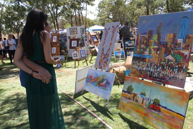 Art lovers admire some paintings on display at the festival