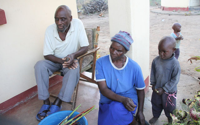 Mr Kayiboni relaxes with his ninth wife Lucia and some of their children