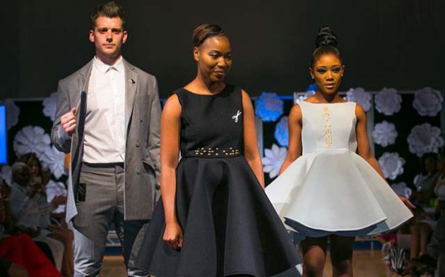 Tapiwa Dingwiza flanked by models wearing some of her creations during the Zimbabwe Fashion Showcase UK recently