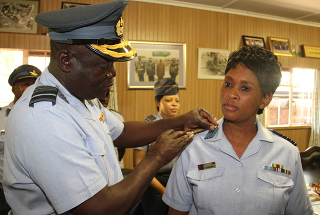 Airforce of Zimbabwe Commander Air Marshal Perrance Shiri bestows a new insignia on Blessings Ndoro