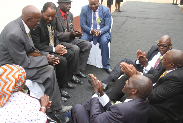 Chief Magistrate Mr Mishrod Guvamombe (extreme right), Judicial Service Commission deputy secretary Mr Walter Chikwana (centre) and Buhera West MP Cde Oliver Mandipaka appear before Headman Murambinda (left) who convicted them of constructing a new magistrates’ court at Murambinda Growth Point without consulting traditional leaders. They were fined three cattle and a goat for the offence. - (Picture by Daniel Nemukuyu)