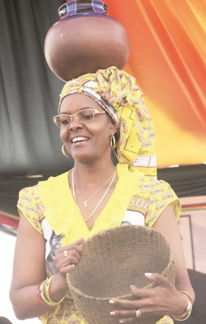 First Lady Amai Grace Mugabe carries a clay pot and basket, part of the goods she received, during her rally in Mbare, Harare, yesterday