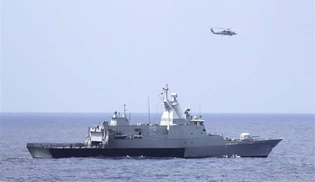 The Royal Malaysian Navy corvette KD Terengganu and a U.S. Navy MH-60R Sea Hawk helicopter from the US Navy guided-missile destroyer USS Pinckney conduct a coordinated air and sea search for a missing.