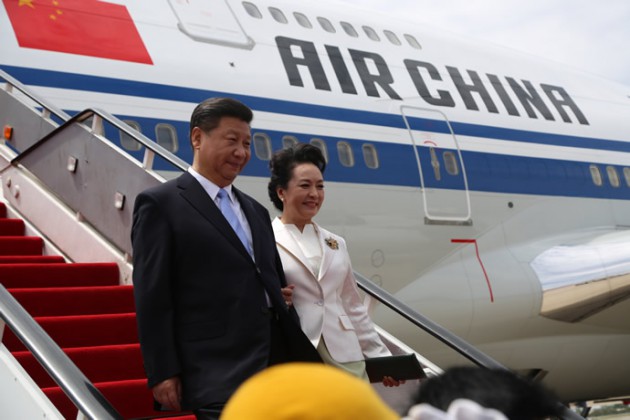 President Xi and First Lady Peng Liyuan arrive at the Harare International Airport