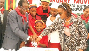 In this file photo, President Mugabe is assisted to cut his birthday cake by the First Lady Amai Grace Mugabe and the First Family.