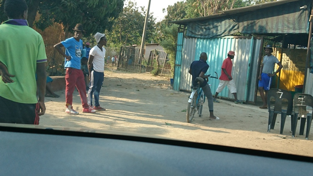 Some of Gogo Nganga’s clients mill outside her home