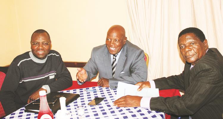 FIRMLY IN CHARGE . . . Dynamos board chairman Bernard Marriot (centre) discusses a point with his fellow board members, secretary Mthokozisi Nkosi (left) and the man in charge of finance, Owen Chandamale, during their board meeting in Harare yesterday