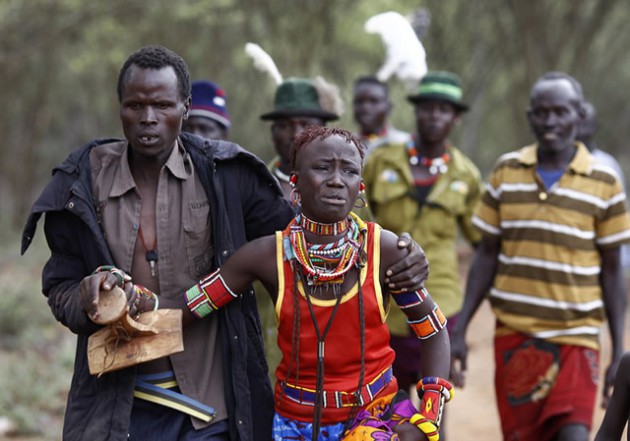 A young girl from Kenya’s Pokot tribe weeps as she’s led away from her home by her future husband’s family. - Reuters/Siegfried Modola