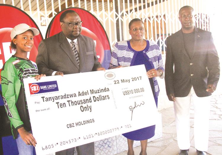 FOR A GOOD CAUSE . . . Tanya Muzinda (left), who is set to tour the United Kingdom this weekend, receives a cheque for $10 000 from CBZ Holdings group marketing and corporate affairs manager Laura Gwatiringa (second from right) in the presence of the permanent secretary in the Ministry of Sport and Recreation Godfrey Chipare and her father Tawanda (right) at Donnybrook Raceway in Harare yesterday