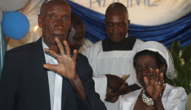 The couple shows off their wedding rings