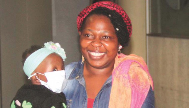 Baby Manqoba and her mother Shamiso Yikoniko on arrival in Zimbabwe