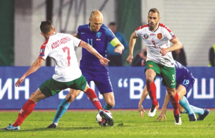 NO DUTCH COURAGE . . . Netherlands captain Arjen Robben (second left) tries to work his way past Bulgaria’s Georgi Kostadinov (left) during their 2018 FIFA World Cup qualification football match in Sofia on Saturday night. — AFP
