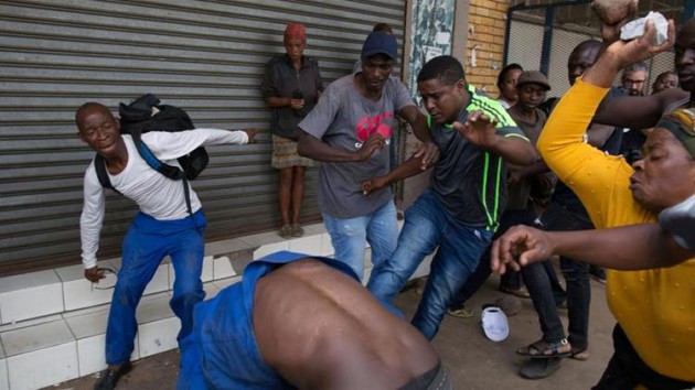 A Nigerian migrant comes under attack outside a church in Pretoria . — Reuters