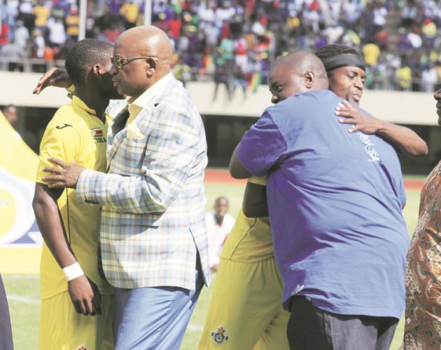 LET’S DO THE JOB . . . ZIFA president Philip Chiyangwa (left) and benefactor Wicknell Chivayo greet the Warriors before their battle against Swaziland at the National Sports Stadium yesterday