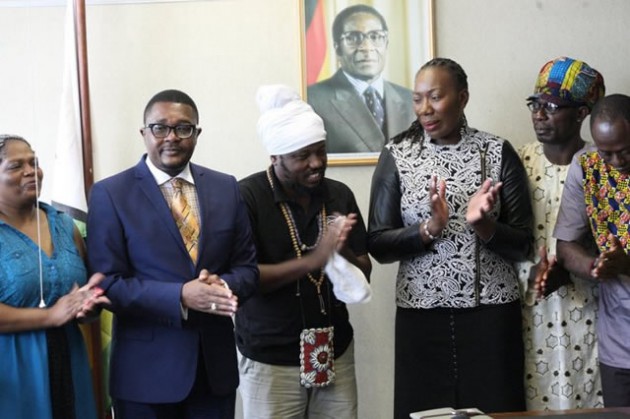 Tourism and Hospitality Industry Minister Walter Mzembi (left), his deputy Annastacia Ndhlovu (third left) applaud Ghanaian reggae artiste Blakk Rasta (second left) and his band members