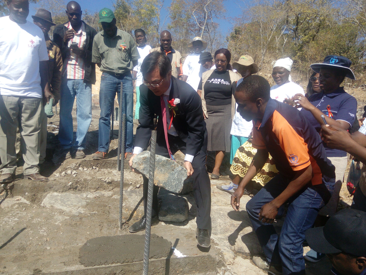 Ambassador Huang Ping laying a stone at the ground breaking ceremony yesterday... pic by Munyaradzi Doma