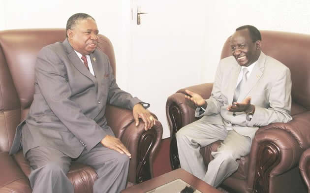 Acting President Phelekezela Mphoko chats to outgoing Ethiopian Ambassador His Excellence Dr Koang Tutlam Dung at his Munhumutapa offices in Harare yesterday. — (Picture by Kudakwashe Hunda)